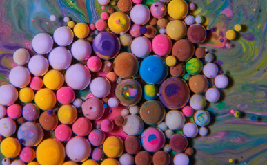 Fototapeta na wymiar Macro photography of colorful bubbles on some fluids that seems to be some kind of unknown worlds.