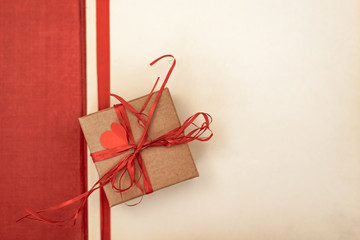 Valentines day hearts, gift box and greeting card over paper background.