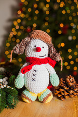 The funny knitted toy snowman for Christmas decoration