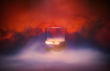 Cocktail in a glass rox glass with ice smoke burns on Lush Lava background. Close up