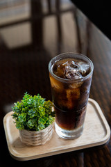 Long island cocktail drink with plant decoration on a black background.