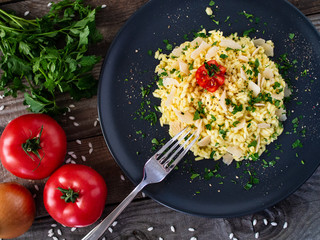 Risotto with parmesan on wooden background