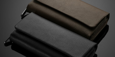 Fashionable leather men's wallet on a dark background - obrazy, fototapety, plakaty