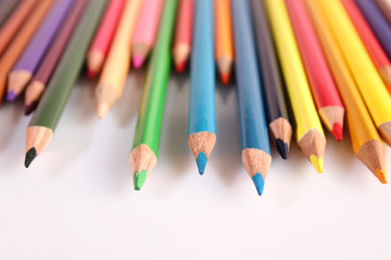 Colored pencils lie in a row