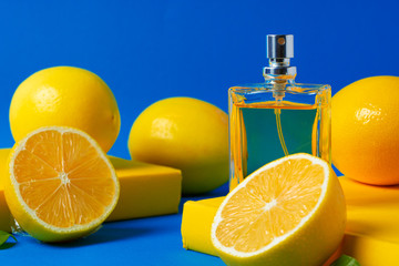 Beautiful composition with bottle of perfume and citrus fruits