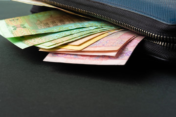 Blue wallet full of money Ukrainian Hryvnia