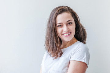Happy girl smiling. Beauty portrait young happy positive laughing brunette woman on white...