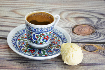cup of Turkish coffee and cookies on wooden table