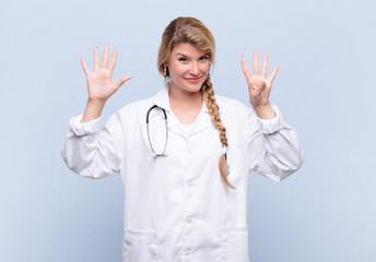 young pretty latin woman smiling and looking friendly, showing number nine or ninth with hand...