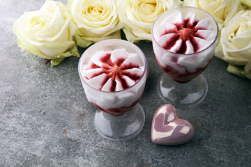 Strawberry dessert or ice cream in glasses and rose, decorated with hearts. Valentines Day background
