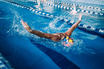 the swimmer swims in the pool in different styles