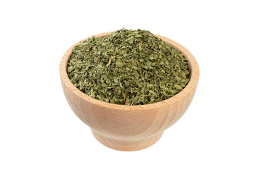 Fototapeta na wymiar dried lovage herb in wooden bowl isolated on white background. spices and food ingredients