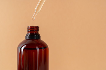 Cosmetic aromatic spa oil in brown glass bottle