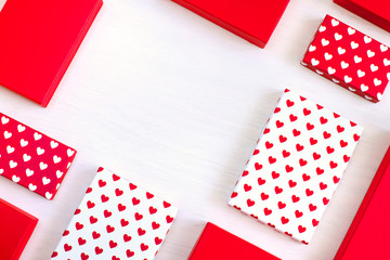 Valentine day composition, flat lay top view. White and red gift boxes with white and red heart on white background. Photo template, background, copy space. View from above