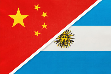 China or PRC vs Argentina national flag from textile. Relationship between asian and american countries.