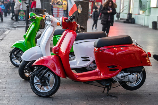 Three vintage scooter Italian flag colors parked on a city street in Odessa