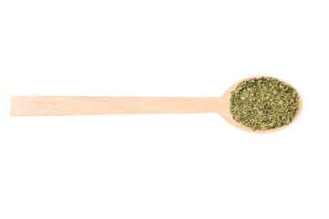 dried lovage herb in wooden spoon isolated on white background. spices and food ingredients. spices and food ingredients