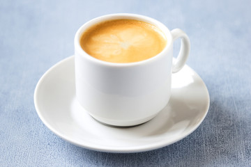espresso in white cup on grey table, close up, concept morning coffee