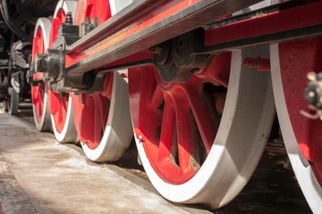 Steel red and white wheels of an old locomotive