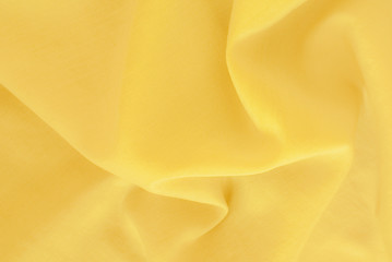 Natural dyes  silk - sustainable fashion background - close up of a fine yellow silk texture
