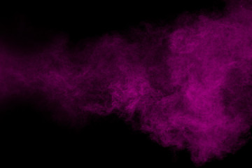 Purple color powder explosion cloud  on black background.Purple dust particles splash.