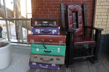 cozy chair from fairy tales with suitcases on floor