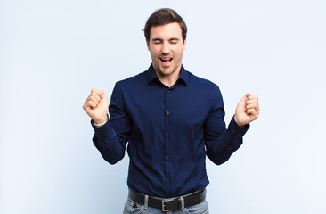  looking extremely happy and surprised, celebrating success, shouting and jumping