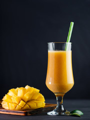 High glass of smoothie cocktail with mango. Exotic healthy Breakfast