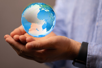 Human Hand Holding The World In Hands.