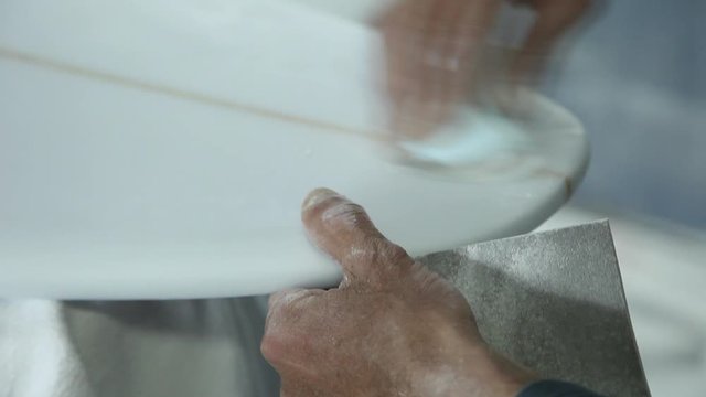 working on handmade surfboard