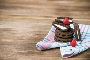 chocolate cookie sandwich on a wooden background. wooden and red hearts. happy Valentine's day. beautiful picture with biscuits. international women day, women's day