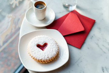 Cup of coffee and cookies on wooden table