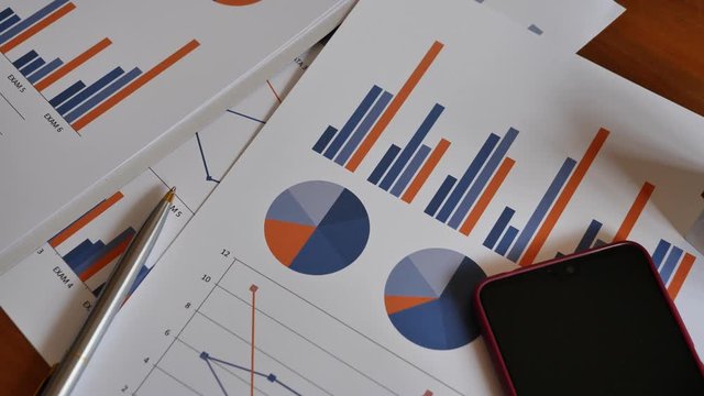 Document financial chart paperwork put on desk table in office business workplace.
