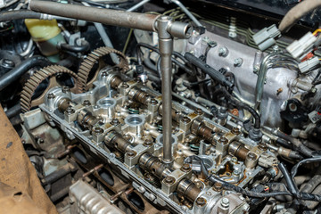 Close up of the cylinder head servicing. Disassembled motor vehicle for repair