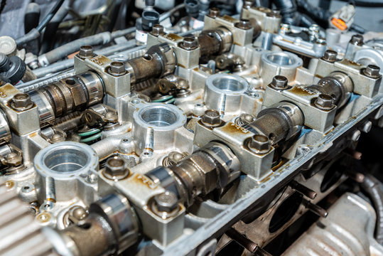 Close Up Of The Cylinder Head Servicing. Disassembled Motor Vehicle For Repair