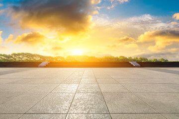 Empty square road and woods background at sunset