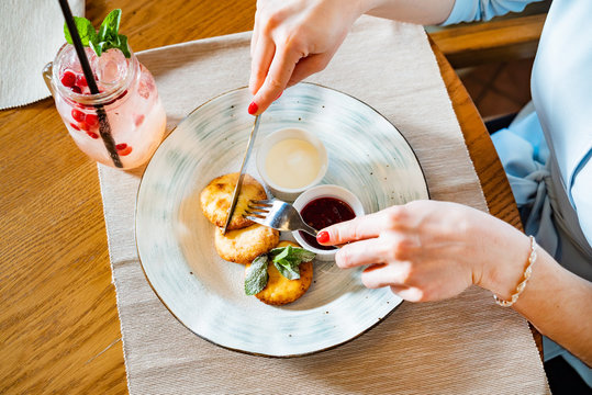 Woman Eating Cottage Cheese Pancakes With Strawberry Dressing