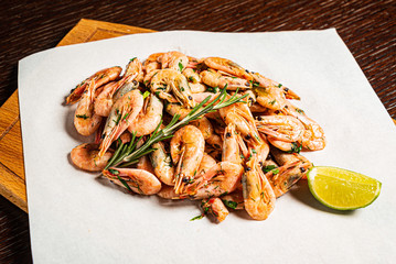 shrimps with lime dressing on the wooden background