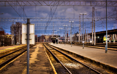 Fototapeta na wymiar Post on a empty train station platform. No people on train station.