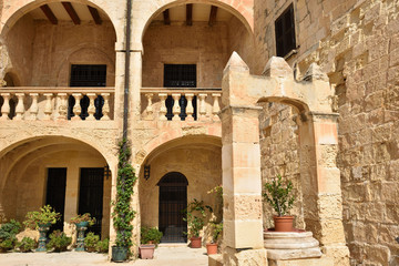 Fototapeta na wymiar Fort St Angelo (Forti Sant Anglu), beautiful inner courtyard of Magisterial Palace inside the fort, famous historical landmark at Birgu Waterfront, Malta, Vittoriosa bay of the Mediterranean sea