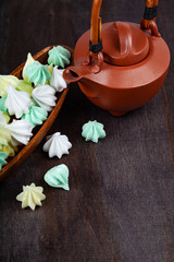 Meringue in a wooden bowl and kettle