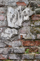 Aged brick wall with cracked plaster
