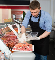 Butcher preparing meat products