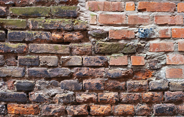 Aged brick wall with cracked plaster background