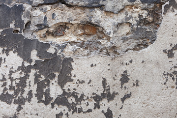 Aged brick wall with cracked plaster background