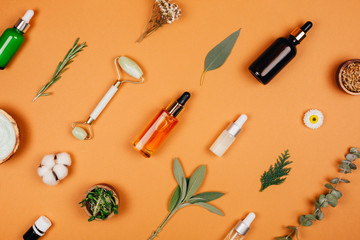 Modern accessories and herbal cosmetics for natural face care. Flat lay style.