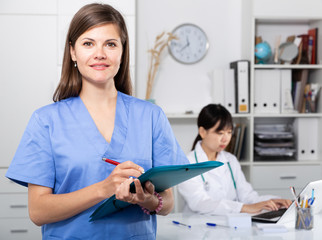 Doctor writing notes on clipboard