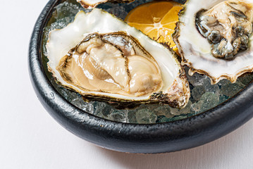 Raw seasonal oysters on ice with lemon