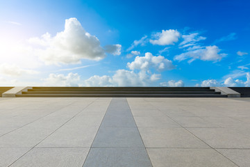 Empty square pavement and blue sky with white clouds
