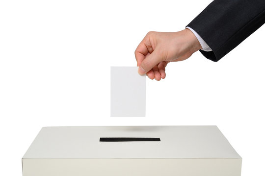 Man's hand down the ballot in the ballot box.